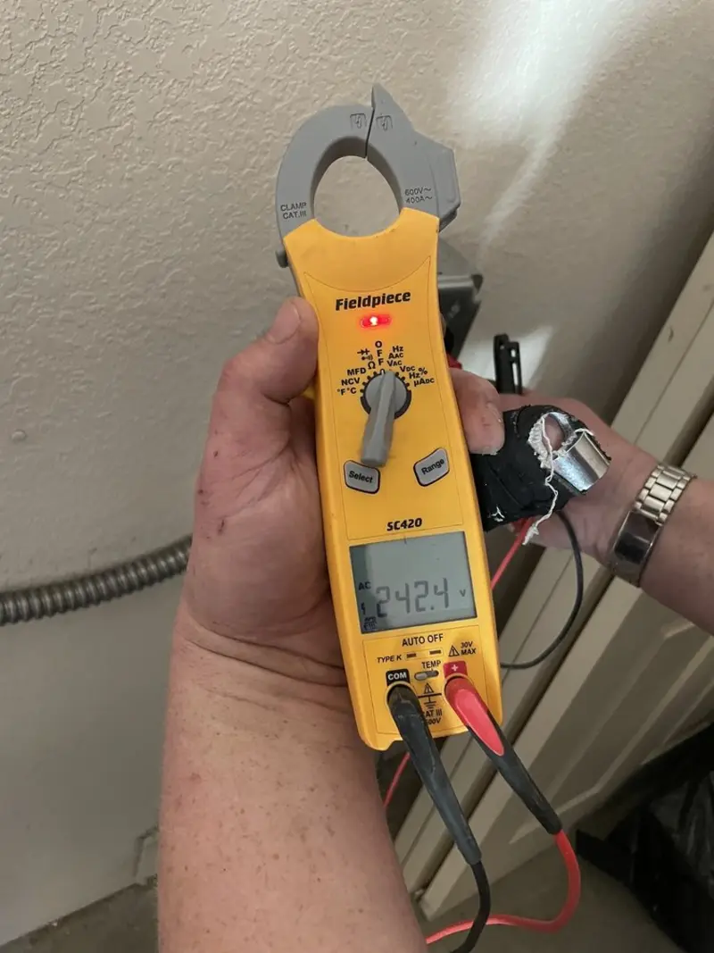 Voltage testing with clamp meter during Outlet Installation in Oneida